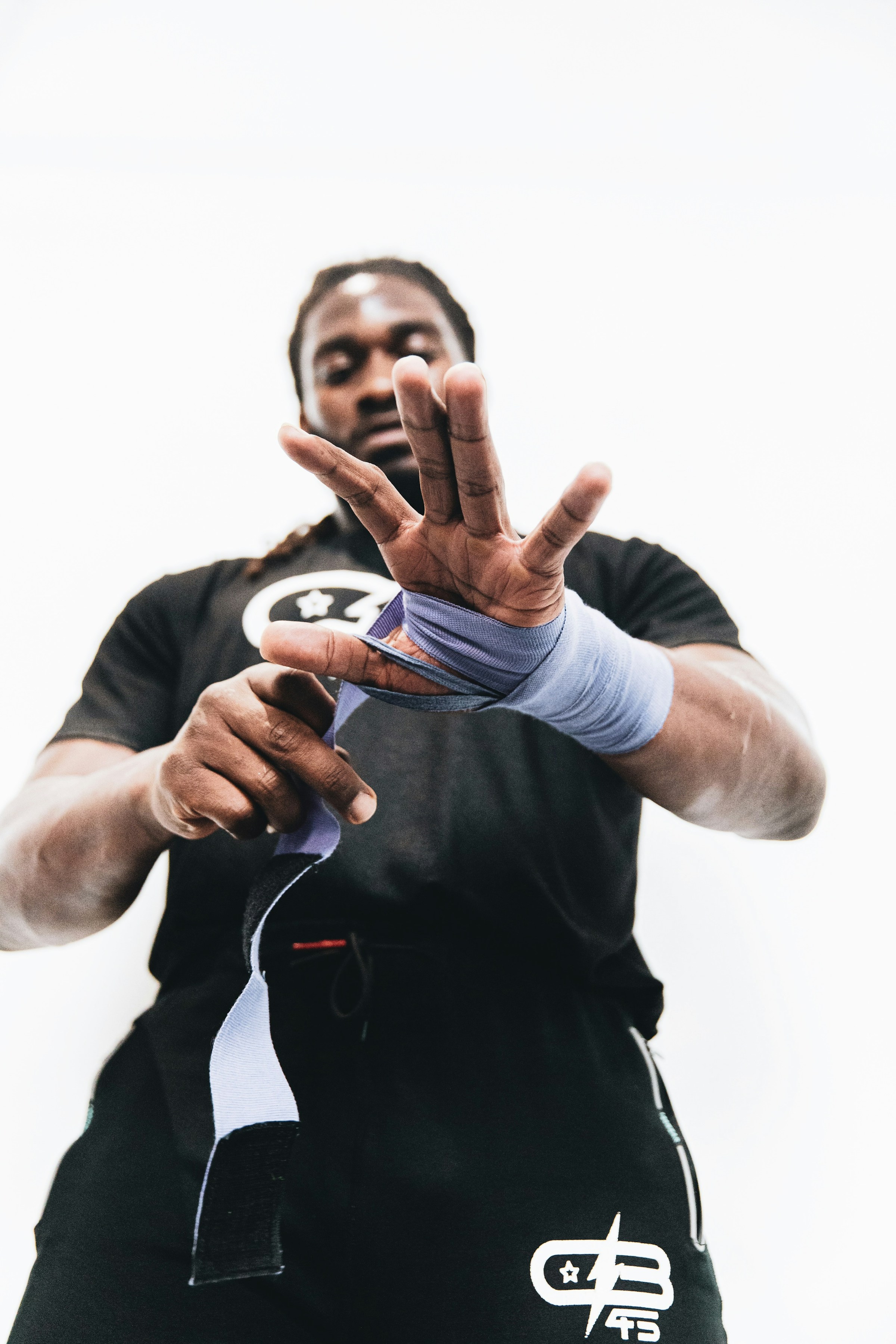 man putting on wrist wraps ready for boxing