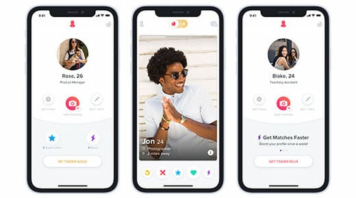 Tinder dating app profile pages open on three smartphones